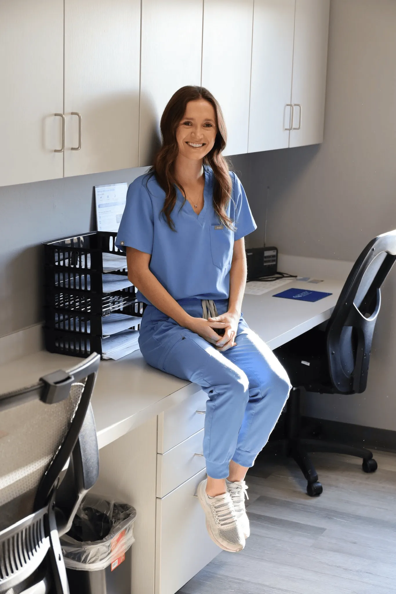 Our nurse practitioner at Comprehensive Spine and Pain, sitting on her desk.