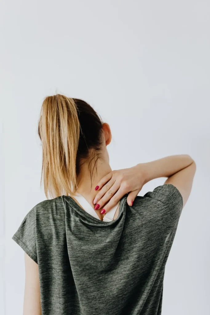 Woman touching her neck from behind after failed back surgery.