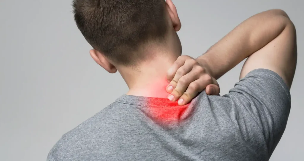 Man pressing fingers to back of neck with red area symbolizing back pain.