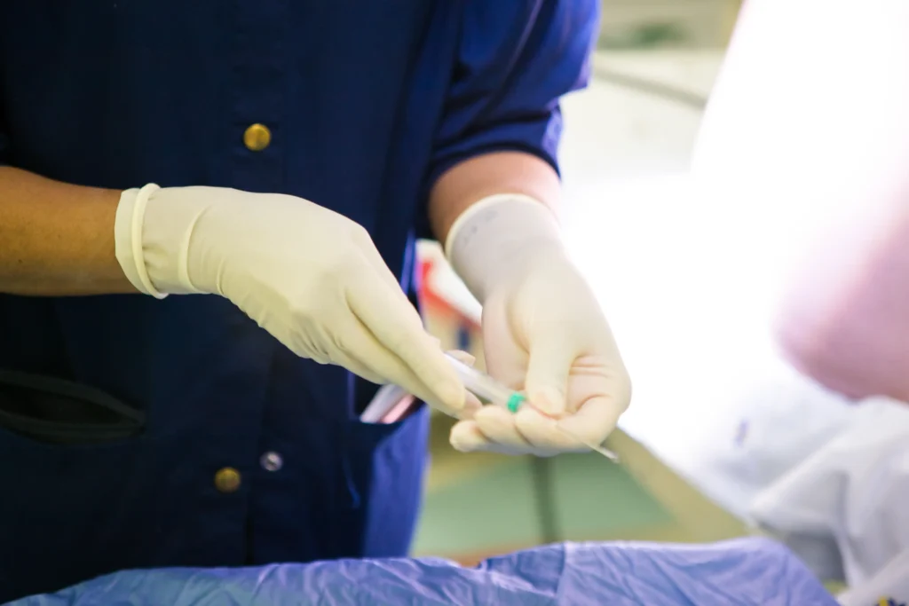 A medical professional preparing an injection as part of treatment options for severe lower back pain.