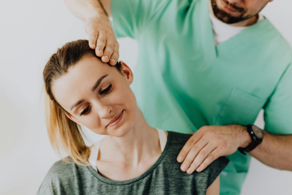 patient getting checked out by doctor for neck pain